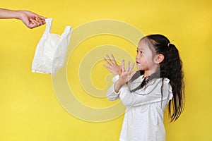 Asian little girl making X sign her arms for needless a white thin polythene plastic bag to Reduce or zero waste isolated on