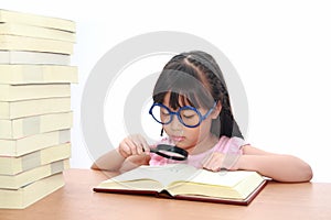 Asian little girl reading a book