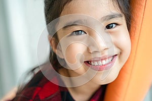 Asian little girl smiling with perfect smile and white teeth in dental care photo