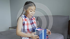 Asian little girl very happy and excited when receives a gift box