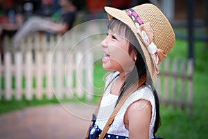 Asian little girl watching his activity ahead and laughing