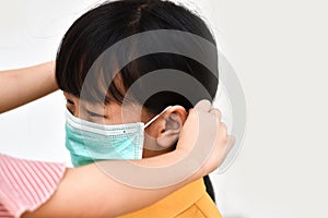 Asian little girl wear a medical mask to avoid contagious viruses. Stop the outbreak Coronavirus