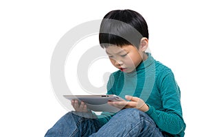 Asian little kid concentrate on reading tablet photo