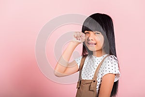 Asian little kid 10 years old bad mood her cry wipe tears with fingers