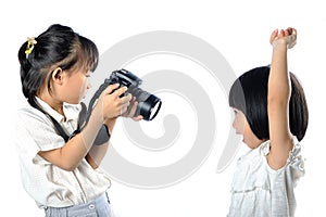 Asian little siblings child taking photograph of each other with