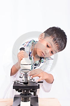 asian little student boy working with microscope