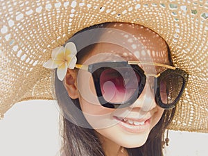 Asian long black hair girl is wearing black sunglasses, straw ha