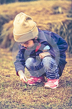 Asian lovely girl in her winter warm clothing playing at farm. O