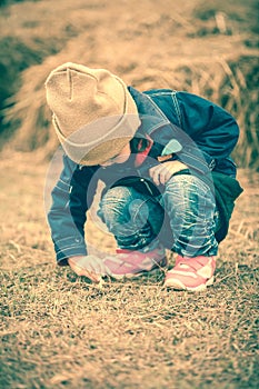 Asian lovely girl in her winter warm clothing playing at farm. O