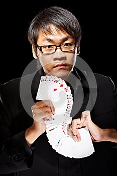 Asian magician with cards