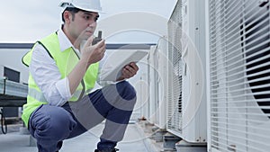 Asian maintenance engineer works on the roof of factory. contractor inspect compressor system and plans installation of air