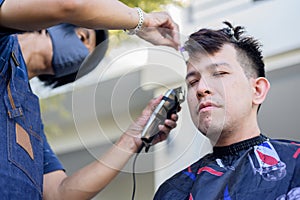 Asian making haircut at home garden. New normal life after Covid-19