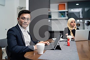 Asian malay couple having a coffee in pantry office photo