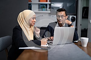 Asian malay couple working together at home