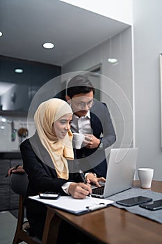 Asian malay couple working together at home