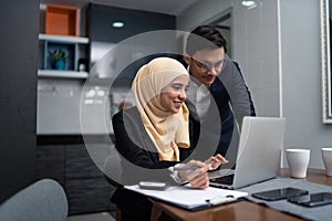Asian malay couple working together at home photo