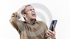 Asian Malay man getting mad and annoying while holding a smartphone photo