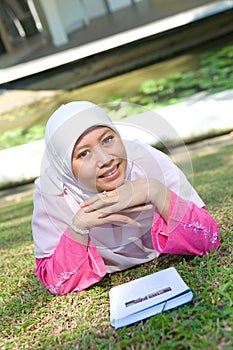 Asian Malay Muslim woman reading
