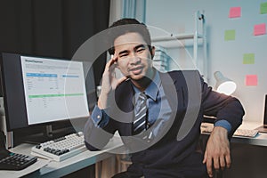 Asian male businessman working in the room. Startup company employees are working in the office at night, overtime, busy work,