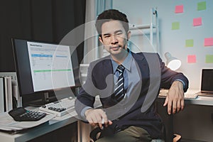 Asian male businessman working in the room. Startup company employees are working in the office at night, overtime, busy work,