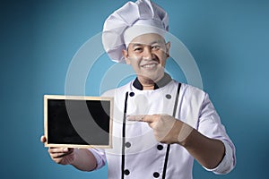 Asian Male Chef Shows Empty Blackboard, Presenting BLank Writing Template, Copy Space