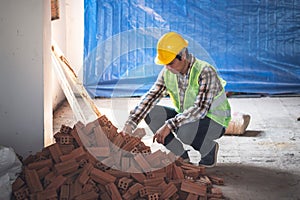 Asian male construction engineer Checking the quality of the bricks