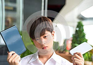 Asian male decide and hesitate to use smart device photo