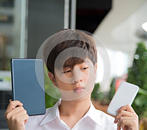 Asian male decide and hesitate to use smart devices photo
