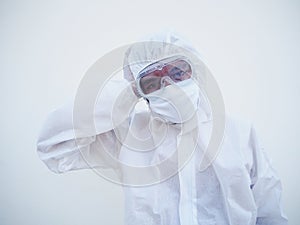 Asian male doctor or scientist in PPE suite uniform showing that feeling strees and headache. coronavirus or COVID-19 concept