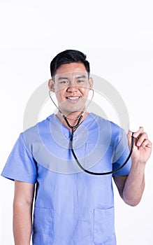 Asian male doctor smiling and using stethoscope while standing on white background