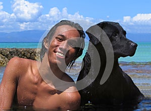 Asian male with dog on beach, close-up.