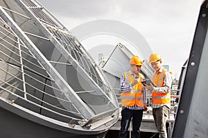 Asian male engineer inspecting pipe fittings and chillers, refrigeration plant refrigeration plant in  factory. male mechanic