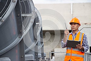 Asian male engineer inspecting pipe fittings and chillers, refrigeration plant refrigeration plant in  factory. male mechanic