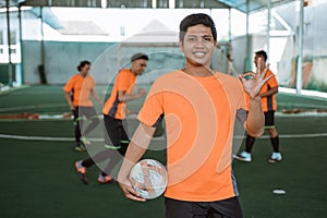 Asian male futsal player smiling with ok hand gesture