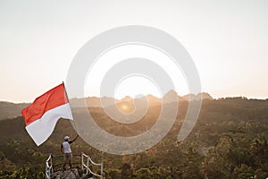 Asian male with indonesian flag celebrating independence day photo