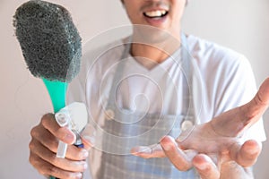 Asian male inspector smile to cleaning staff in bathroom disinfectant sprayers and germs  Metaphor for cleaning Get rid of germs