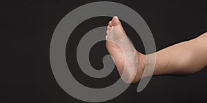 Asian Male leg and barefoot with Soles of the feet is isolated on black background