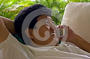 Asian Male Relaxed On The Phone With A Friend