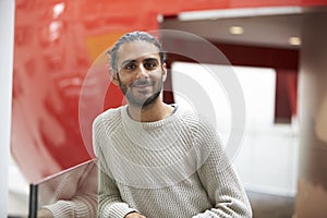 Asian male student in modern university building, portrait