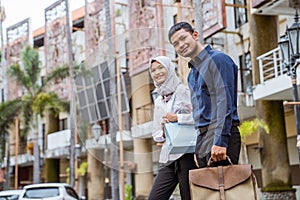 Asian male and veiled female workers will work in city