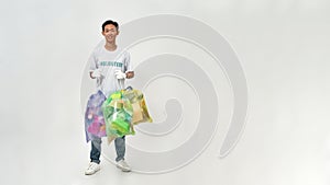 Asian male volunteer holding sorted garbage bags