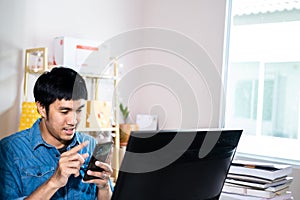 Asian man administrator staff call center in home service office assistance work from home looking data customer from computer