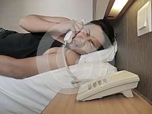 Asian Man Answering Phone Call when Waking Up on Bed in the Morning