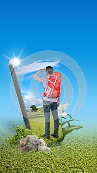 Asian man with a backpack standing with a field view on the mobile phone screen