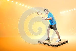 Asian man with badminton racket holding shuttlecock and ready in serve position