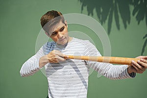 Asian man with baseball bat