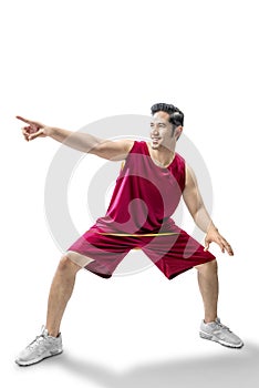Asian man basketball player in the pose of dribbling the ball