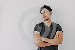 Asian man in black t-shirt crossing his arms isolated on white.