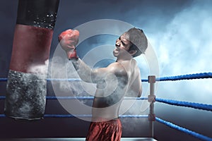 Asian man boxer practicing with punching bag