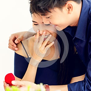 Asian man boyfriend give a box of ring to his girlfriend, she feels excited and very happy